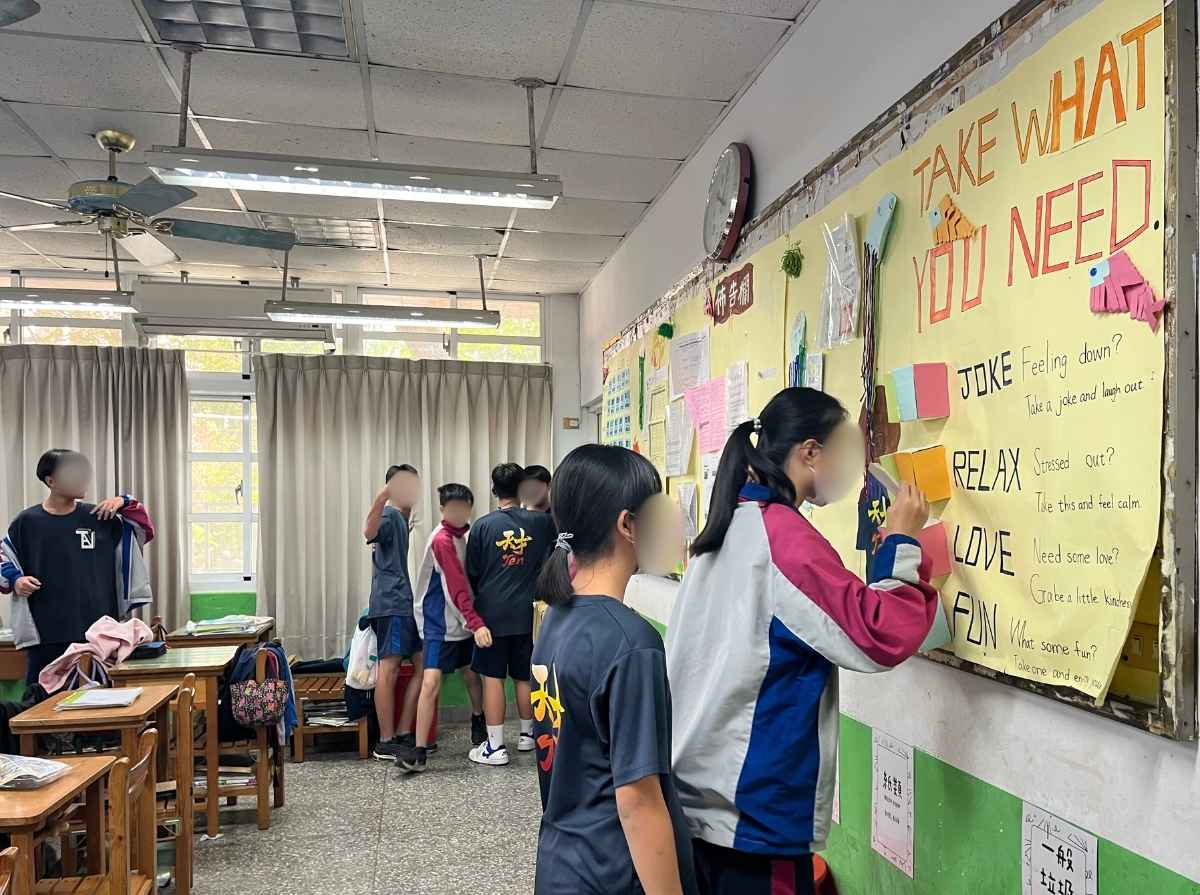 During break time, students visit the classroom bulletin board to pick and read “Ten Talent” cards.